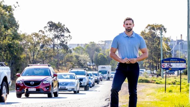 Division One Gold Coast City Council candidate Mark Hammel on the busy Eastern Service Road at Ormeau.