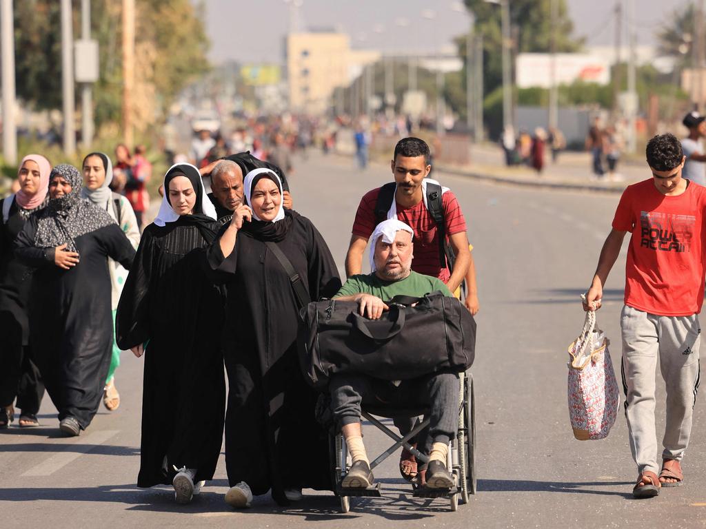 Palestinians fleeing Gaza City towards the southern areas walk on a road amid the ongoing battles between Israel and the Palestinian Islamist group Hamas. Picture: AFP