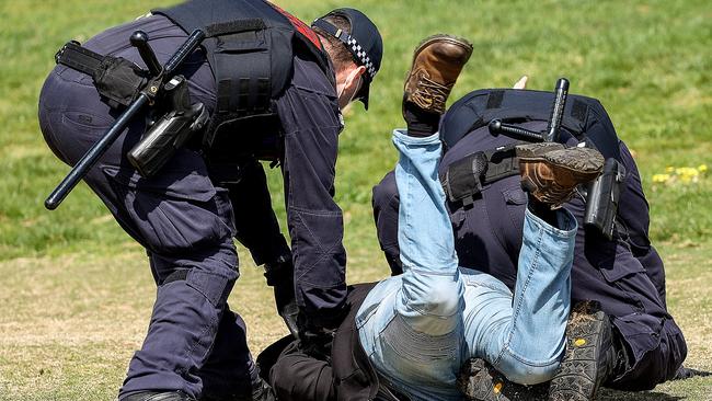 A Reclaim The Line protester is tackled by police at Maribyrnong Park in Maribyrnong. Picture: NCA NewsWire / Ian Currie