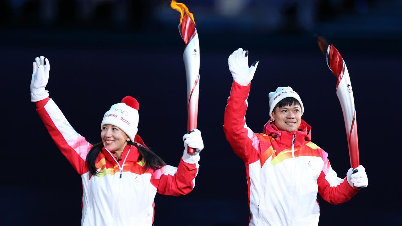 The torch bearers carry the Olympic flame during the Opening Ceremony. Picture: Getty Images