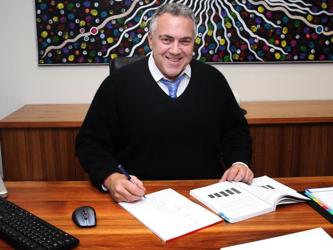 Joe Hockey has been working hard on the budget from behind his desk as Mr Morrison spruiks it. Pic: Gary Ramage.