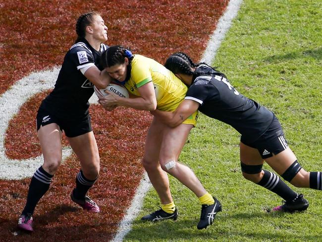 Australia's Charlotte Caslick is tackled by New Zealand's Sarah Goss during the final of the Women's tournament 2018 Rugby World Cup Sevens game. Picture: Geoffroy Van der Hasselt