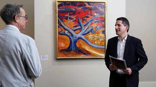 Art specialist Brett Ballard and Geoffrey Smith with Brett Whiteley’s The Arrival — A Glimpse in the Botanical Gardens. Picture: Jane Dempster