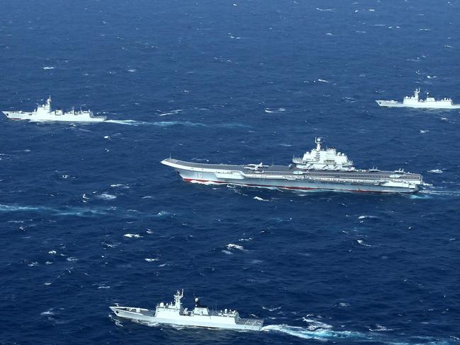 (FILES) This aerial file photo taken on January 2, 2017 shows a Chinese Navy formation, including the aircraft carrier Liaoning (C), during military drills in the South China Sea. - US Secretary of State Mike Pompeo said on July 13, 2020 the United States would treat Beijing's pursuit of resources in the dispute-rife South China Sea as illegal, ramping up support for Southeast Asian nations and triggering a furious response from Beijing. (Photo by STR / AFP) / China OUT