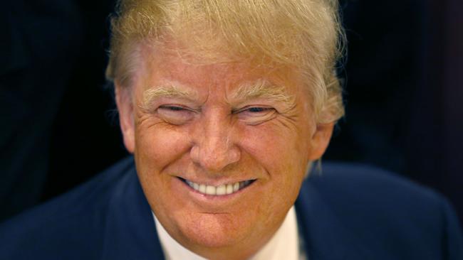 FILE - In this June 29, 2015, file photo, Republican presidential candidate Donald Trump smiles for a photographer before he addresses members of the City Club of Chicago, in Chicago. As other presidential candidates fight to raise money, Trump is reminding everyone he’s already got a lot of it. The celebrity businessman’s campaign was expected to reveal details on July 15 of his fortune, which he estimated last month at nearly $9 million when announcing his Republican presidential candidacy. (AP Photo/Charles Rex Arbogast, File)