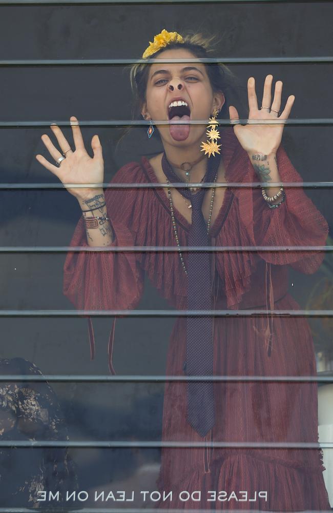 Paris Jackson licks the glass inside the Myer marquee at the Melbourne Cup. Picture: Splash News