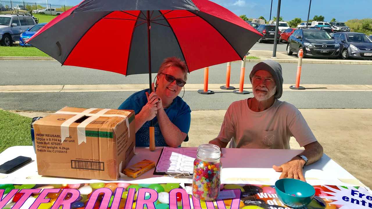 Debbie Pruden and Leonard Thompson of Mackay Conservation Group holds Adani quiz outside polling station at Northern Beaches High School. Picture: Angela Seng