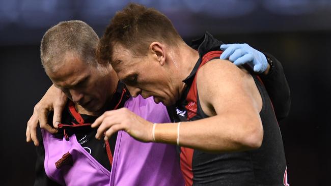 Brendon Goddard is helped off the ground after hurting his knee against the Saints. Picture: AAP