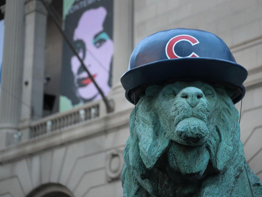 Behind the lion sculpture outside the Art Institute of Chicago (temporarily wearing a baseball batting helmet in honour of the Chicago Cubs making it into the World Series in 2016) is a large bill poster promoting Andy Warhol’s Elizabeth Taylor screen print series. Picture: Scott Olson/Getty Images/AFP