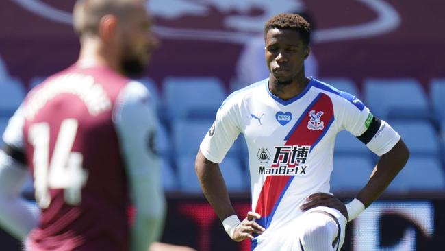 Crystal Palace's Ivorian striker Wilfried Zaha kneels prior the English Premier League football match between Aston Villa and Crystal Palace at Villa Park in Birmingham, central England on July 12, 2020. (Photo by Tim Keeton / POOL / AFP) / RESTRICTED TO EDITORIAL USE. No use with unauthorized audio, video, data, fixture lists, club/league logos or 'live' services. Online in-match use limited to 120 images. An additional 40 images may be used in extra time. No video emulation. Social media in-match use limited to 120 images. An additional 40 images may be used in extra time. No use in betting publications, games or single club/league/player publications. /