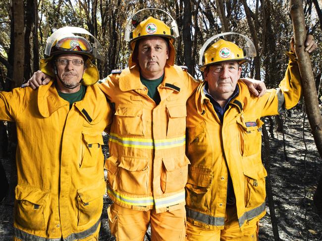 Rural Fire Service Firefighters Scott Brooks, (1st Officer, Valdora,) Mark Smith, (Officer, Doonan), and Peter Garrett, (1st Officer, Maroochy River) in burnt out scrub just off David Low Way. Picture: Lachie Millard