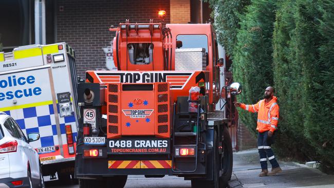 A crane tends to the trapped body at Fort Street High School, where a stone mason has been killed by falling scaffolding and concrete. Picture: Justin Lloyd.