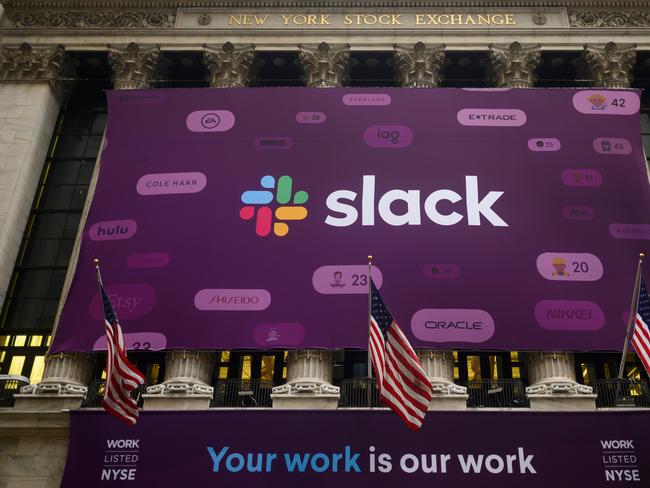 (FILES) In this file photo taken on June 20, 2019, the logo of Slack Technologies Inc. adorns the New York Stock Exchange after the company's public offering. - Salesforce on December 1, 2020, announced a $27.7 billion deal to buy online collaboration firm Slack, giving the business software giant a broader array of tools  as the pandemic fuels a remote work trend. (Photo by Johannes EISELE / AFP)