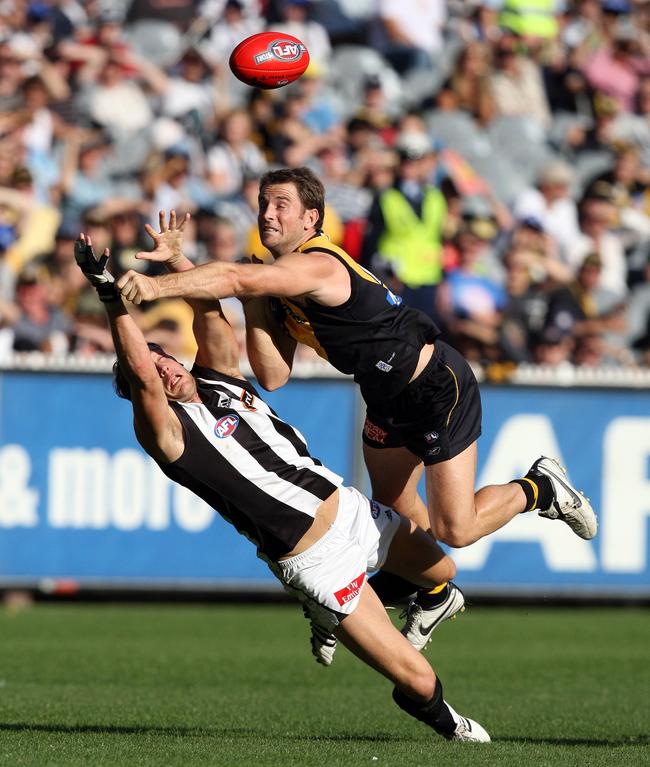 Richmond’s Joel Bowden gives Collingwood’s Josh Fraser no quarter. Picture: Michael Dodge