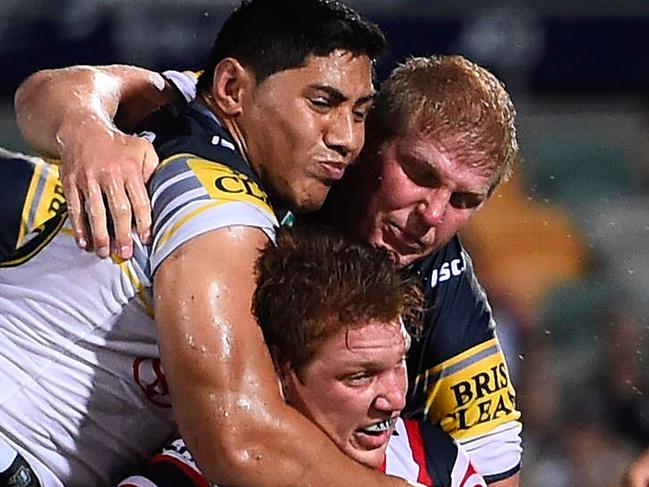 TOWNSVILLE, AUSTRALIA - MARCH 07: Dylan Napa of the Roosters is tackled by Jason Taumalolo of the Cowboys and Ben Hannant of the Cowboys during the round one NRL match between the North Queensland Cowboys and the Sydney Roosters at 1300SMILES Stadium on March 7, 2015 in Townsville, Australia. (Photo by Ian Hitchcock/Getty Images)