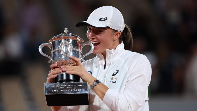 Is it real? Iga Swiatek of Poland bites the trophy after winning against Coco Gauff of the US during the women’s singles final match on Day 14 of the 2022 French Open at Roland Garros on Saturday. Picture: Clive Brunskill / Getty Images