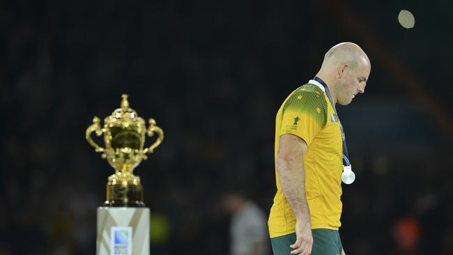 TOPSHOTS Australia's hooker and captain Stephen Moore leaves the podium after recieving his runners up medal during the final match of the 2015 Rugby World Cup between New Zealand and Australia at Twickenham stadium, south west London, on October 31, 2015. AFP PHOTO / GLYN KIRK RESTRICTED TO EDITORIAL USE, NO USE IN LIVE MATCH TRACKING SERVICES, TO BE USED AS NON-SEQUENTIAL STILLS