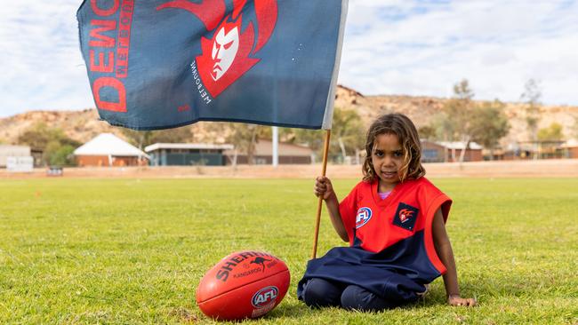 Shalaya Young, 4, on the newly grassed Santa Teresa Football Oval in Northern Territory near Alice Springs on May 3, 2021. Pictures: Emma Murray