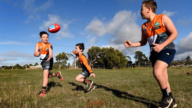 Tyler, Dylan and James go for a run on the land earmarked for the New Gisborne Regional Sports Precinct. Picture: David Smith