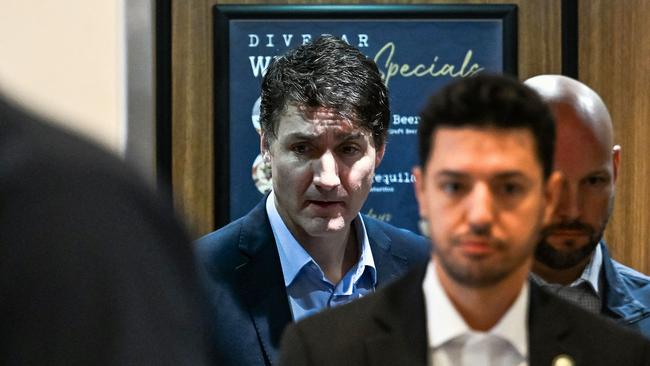 Canadian Prime Minister Justin Trudeau, centre, leaves the hotel for the airport, in West Palm Beach, Florida. Picture: AFP