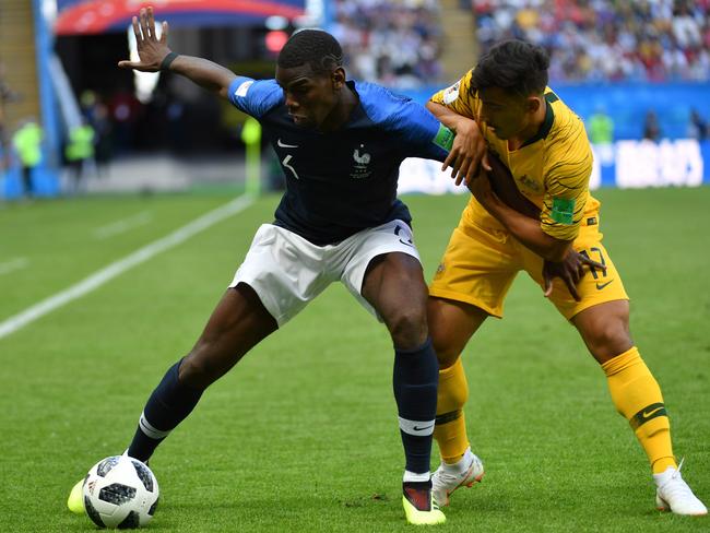 MIXING WITH THE GREATS: Daniel Arzani battles with French star Paul Pogba in the Socceroos’ opening World Cup clash. Pic: AFP