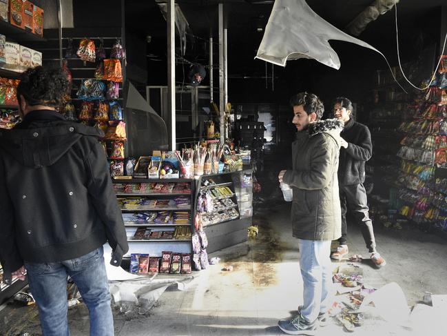 MELBOURNE, AUSTRALIA - NewsWire Photos June 06, 2024: Staff inspect the fire damaged interior of Harry Mart on Chapel Street Prahran after an early morning arson attack. Picture: NCA NewsWire / Andrew Henshaw