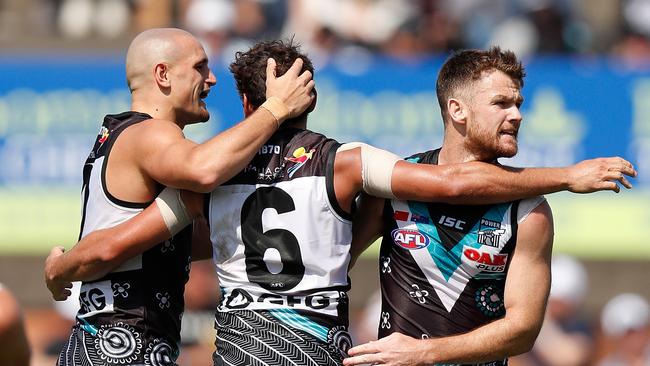 Robbie Gray (right) celebrates a goal with Port Adelaide teammates Sam Powell-Pepper (left) and Steven Motlop against St Kilda in China last week. Picture: MICHAEL WILLSON (AFL Photos).