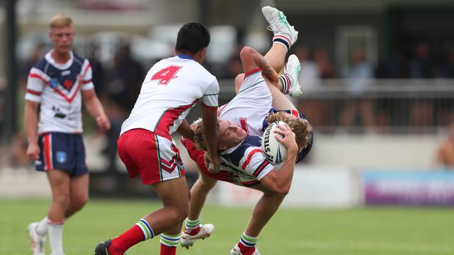 Central Coast Roosters player Jake Herring upended against the Monaro Colts in round one of the Laurie Daley Cup. Picture: Sue Graham