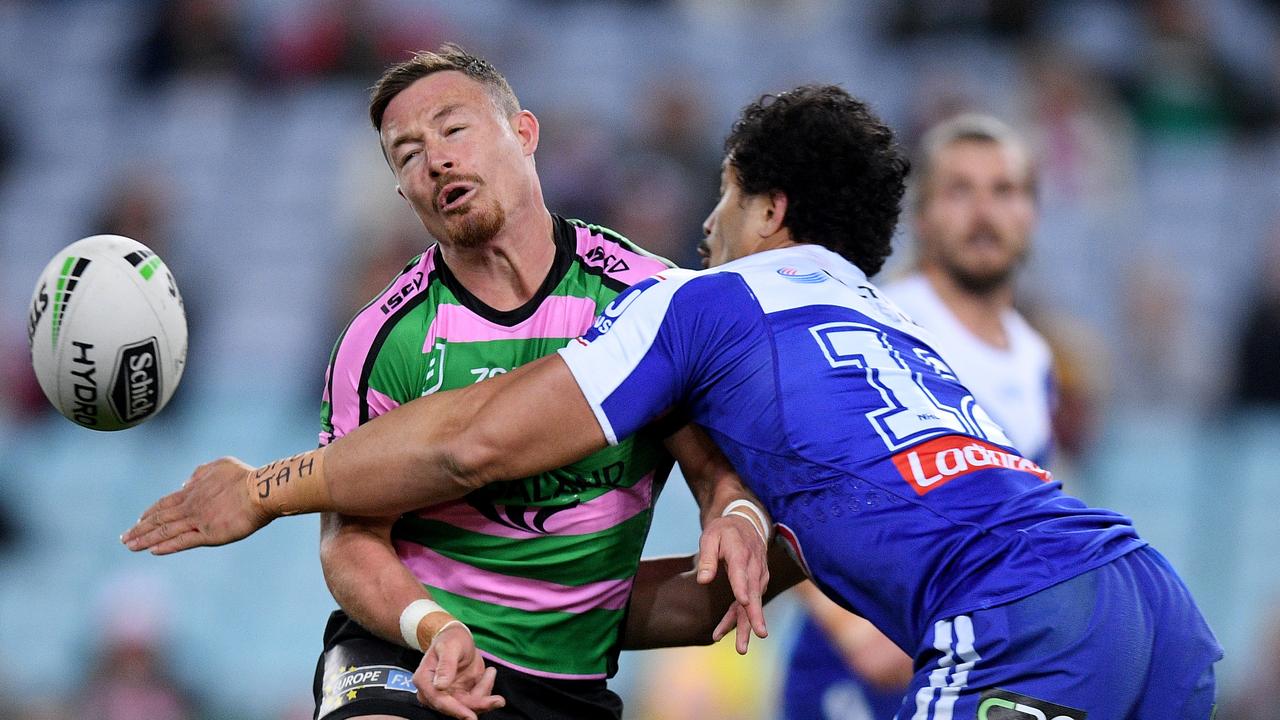 Damien Cook of the Rabbitohs is tackled by Corey Harawira-Naera