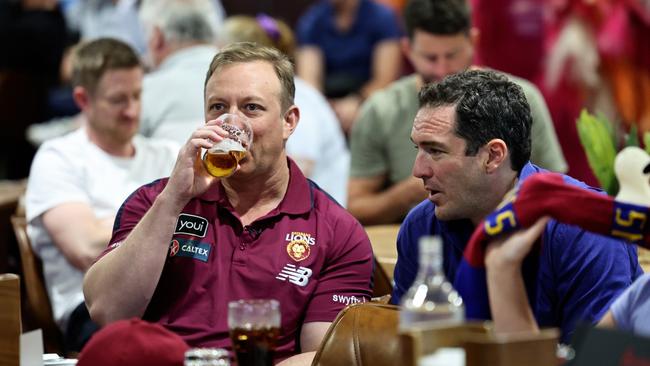 Queensland Premier Steven Miles enjoys a beer while watching the 2024 AFL grand final match between the Brisbane Lions and the Sydney Swans with Sky News reporter Peter Stefanovic at Cazalys Sports Club, Cairns. Picture: Brendan Radke