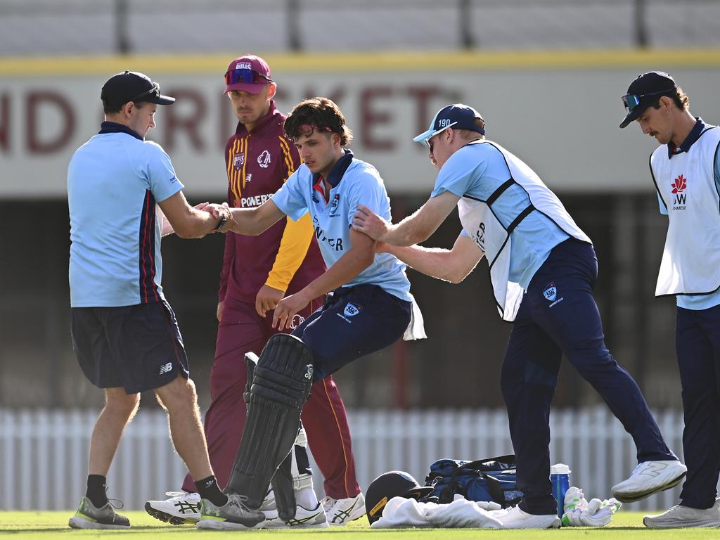 Sam Konstas is helped up by team mates after going down during the ODC match against Queensland. Picture: Getty Images