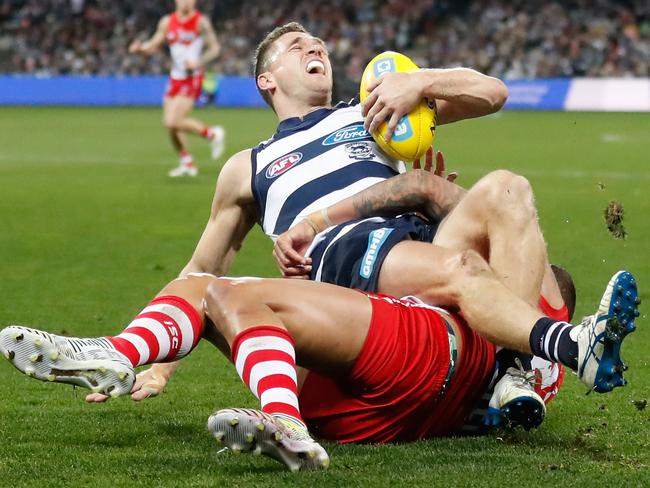 Joel Selwood of the Cats is tackled by Lance Franklin of the Swans.