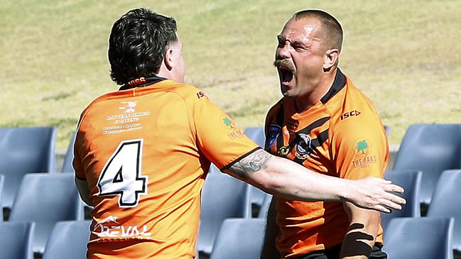 Hear me roar: Centre Jaydn Phillips congratulates a loud Tony Campbell after his try. Picture: John Appleyard