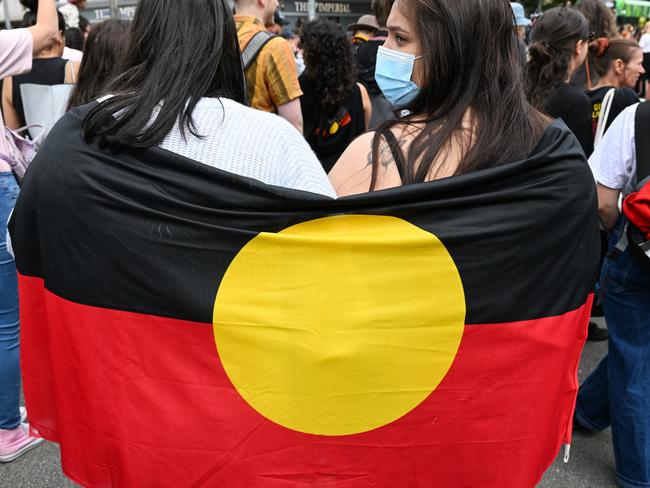 MELBOURNE, AUSTRALIA - JANUARY 26: Protesters participate in the Treaty Before Voice Invasion Day Protest outside Parliament House on January 26, 2023 in Melbourne, Australia.  Australia Day, formerly known as Foundation Day, is the official national day of Australia and is celebrated annually on January 26 to commemorate the arrival of the First Fleet to Sydney in 1788. Many indigenous Australians refer to the day as 'Invasion Day' and there is a growing movement to change the date to one which can be celebrated by all Australians. (Photo by Alexi J. Rosenfeld/Getty Images)