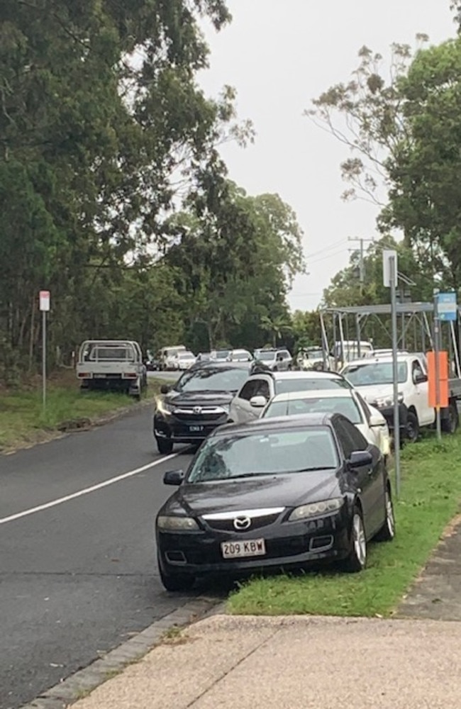 Residents stranded on the roadside at Ormeau as police manhunt continues. Picture: Greg Stolz