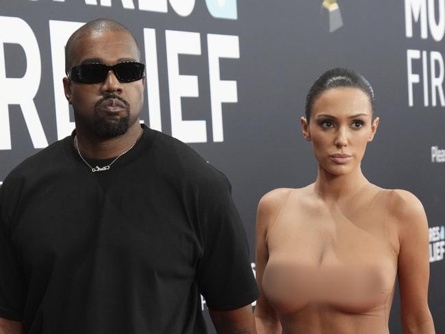 EDS NOTE: NUDITY - Kanye West, left, and Bianca Censori arrive at the 67th annual Grammy Awards on Sunday, Feb. 2, 2025, in Los Angeles. (Photo by Jordan Strauss/Invision/AP)