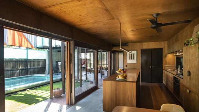 Looking out to the pool area from the kitchen of Bligh Graham Architects’ Live Work Share home. Picture: Mark Cranitch.