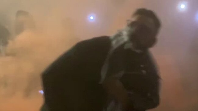 Vision released by NSW Police of a man allegedly throwing a flare at the Sydney Opera House, who they think could assist with inquiries. Picture: NSW Police