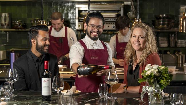 Eleven is hosting a $300 a head dinner with Penfolds later this month. Staff member Clayton Johnson serving Divesh Lormorh and Nikki Potter. Picture: Naomi Jellicoe