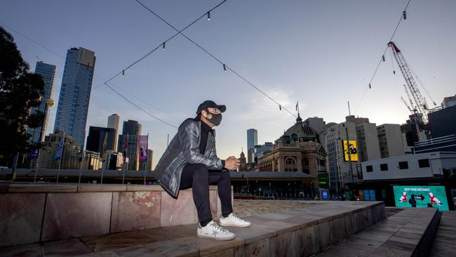 A man feeds seagulls in Federation Square in the last hours before Melbourne is under strict curfew and a state of emergency. Picture: NCA NewsWire / David Geraghty