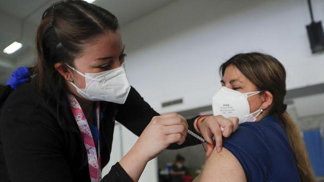 A health worker receives a dose of the Pfizer. Picture: AFP