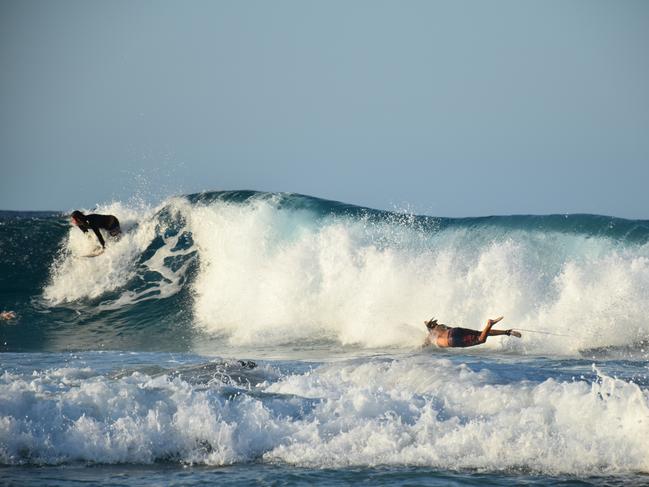 Young swimmers enjoying the surf generated by Tropical Cyclone Oma on the Gold Coast. Picture: Mark Furler.