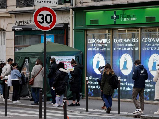 Pedestrians queue outside a pharmacy to receive Covid-19 antigenic tests in Paris as Covid-19 cases soar in Europe. Picture: AFP