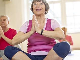 Happy seniors doing yoga