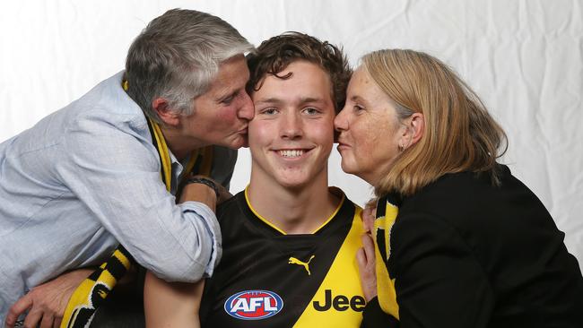 Richmond draftee Riley Collier-Dawkins gets a kiss from his mums Chris Dawkins (left) and Jacinta Collier. Picture: Michael Klein