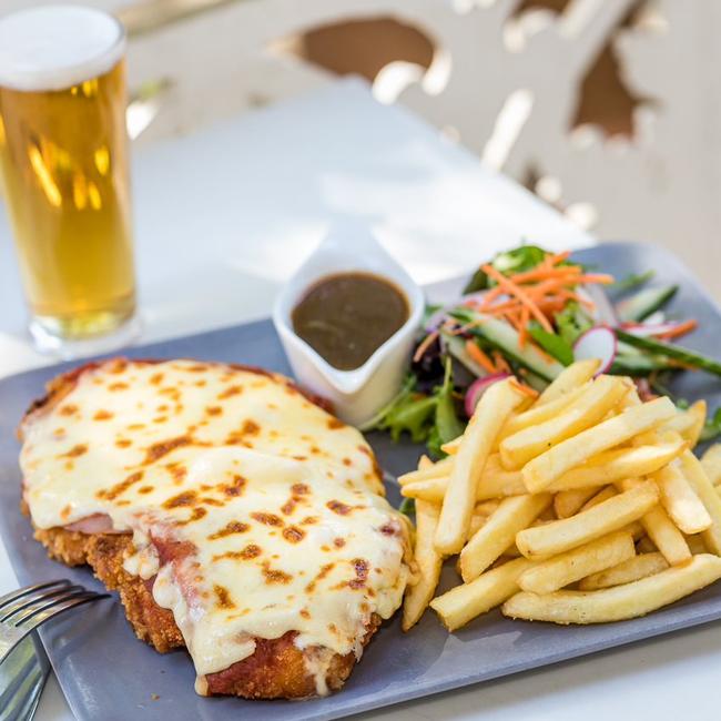 The Regatta Hotel’s hearty Chicken Parmie is served with chips, salad and gravy. Photo: The Regatta Hotel