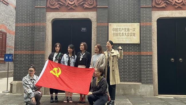 Tourists in Shanghai on Thursday, posing outside of the site of the first National Congress of the Chinese Communist Party. Picture: Will Glasgow