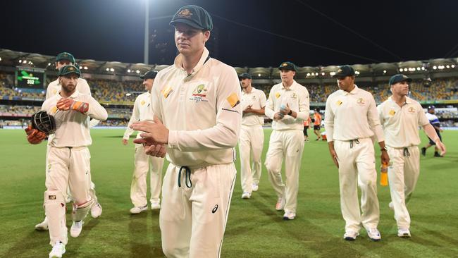 Australian captain Steve Smith leads his players from the field on Friday night after they moved to the cusp of victory over Pakistan in the first Test in Brisbane.