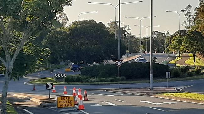 Residents near a tense standoff between police and two men claim the pair are armed and have barricaded themselves inside a house on the Gold Coast.