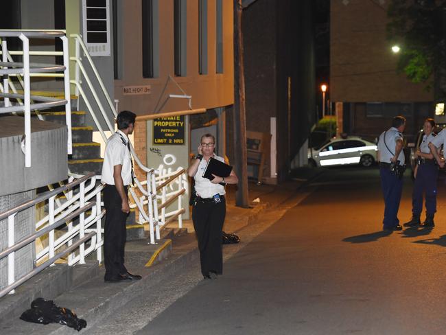 Police investigate the crime scene where two men were stabbed with one left fighting for life in hospital. Picture: Gordon McComiskie